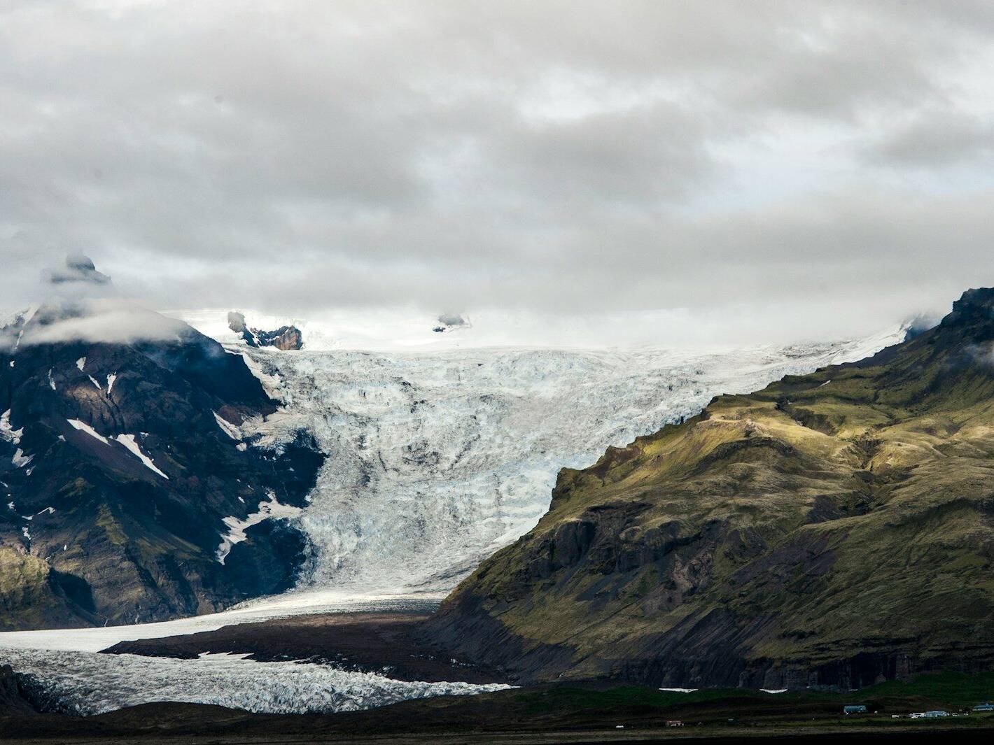 white and black mountain under white clouds during daytime