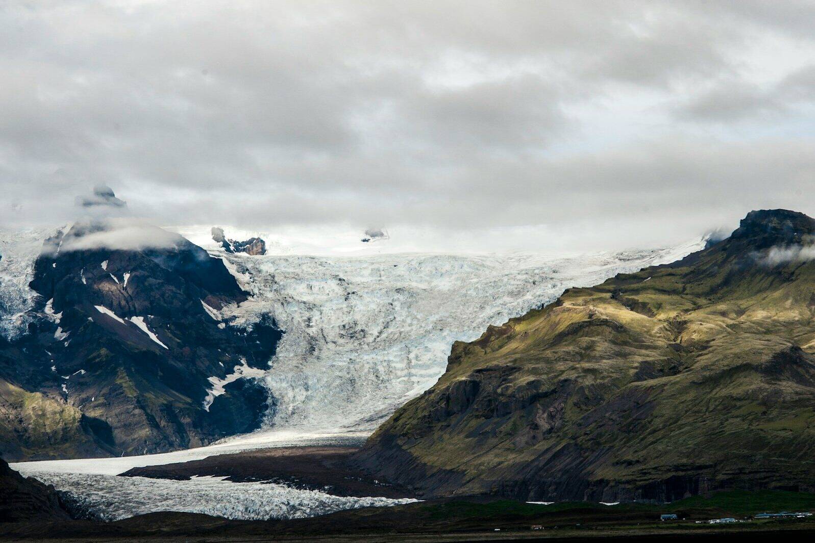 white and black mountain under white clouds during daytime