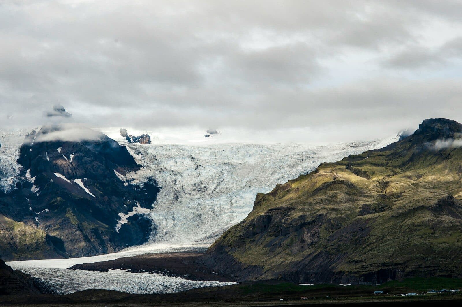 white and black mountain under white clouds during daytime