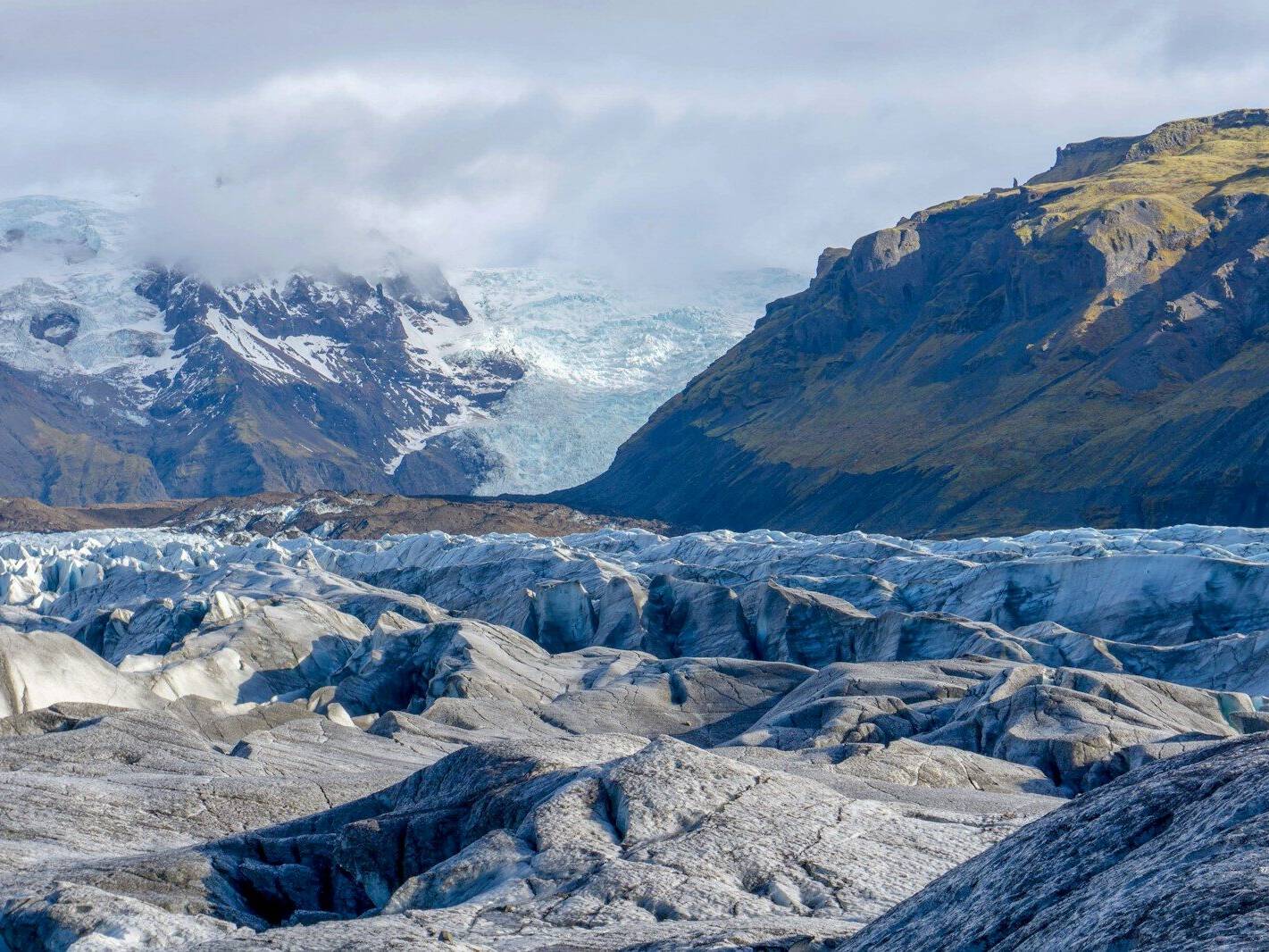 glaciers by mountains during daytime